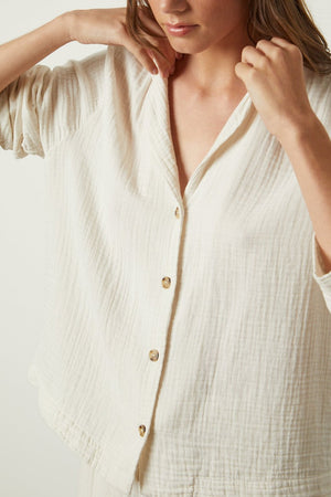 The model is wearing a Jenny Graham Home white button down shirt.