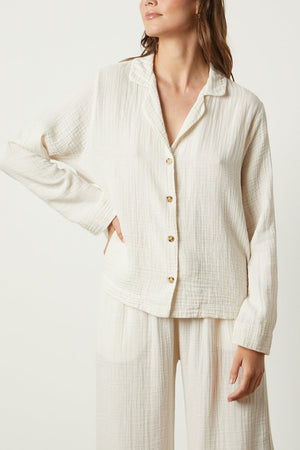 The model is wearing a white Jenny Graham Home pyjama shirt and pants.