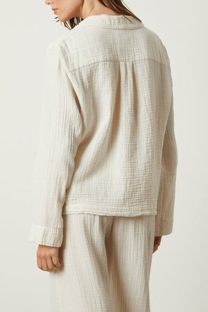 The back view of a woman wearing a Jenny Graham Home PAJAMA SHIRT and pants.