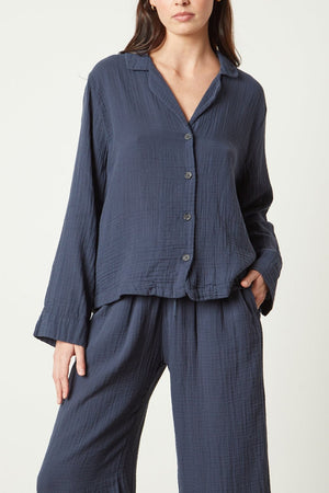The model is wearing a navy linen PAJAMA SHIRT from Jenny Graham Home and wide leg pants.