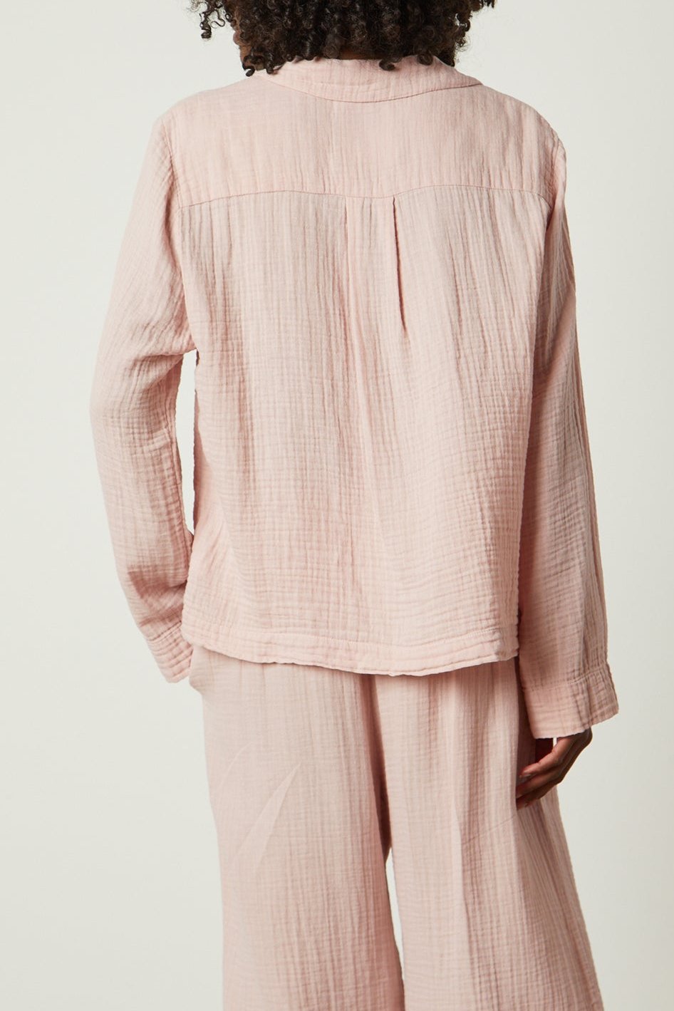 the back view of a woman wearing a pink Jenny Graham Home PAJAMA SHIRT and pants.-25519547809985