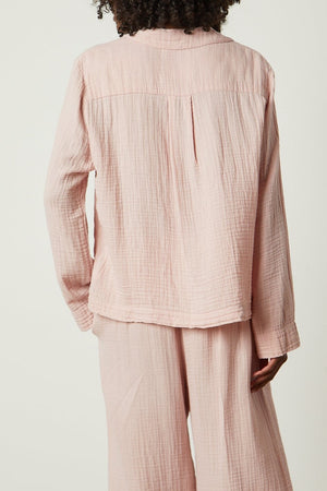 the back view of a woman wearing a pink Jenny Graham Home PAJAMA SHIRT and pants.