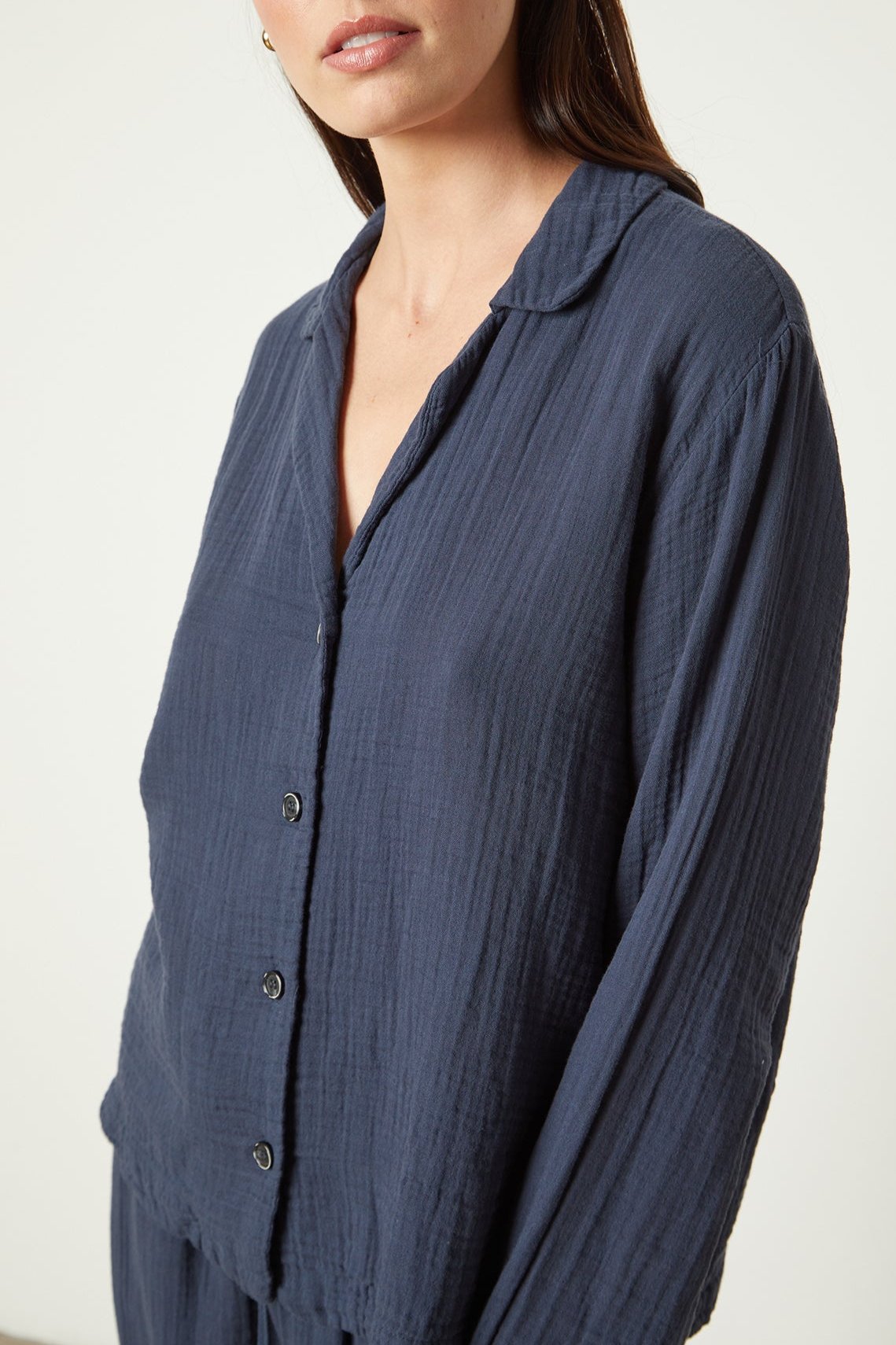 The model is wearing a blue PAJAMA SHIRT and pants by Jenny Graham Home.