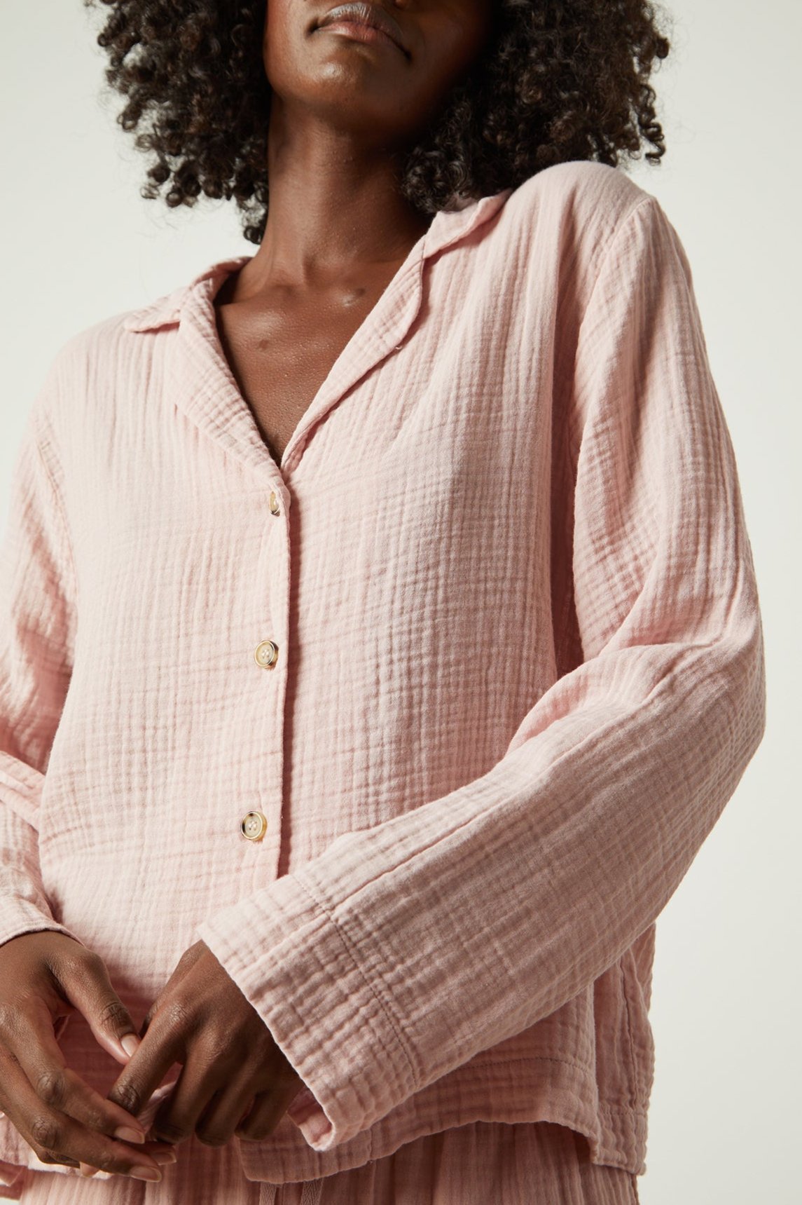 The model is wearing a Jenny Graham Home pink pajama shirt.