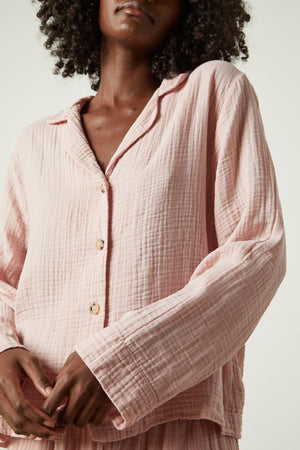 The model is wearing a Jenny Graham Home pink pajama shirt.
