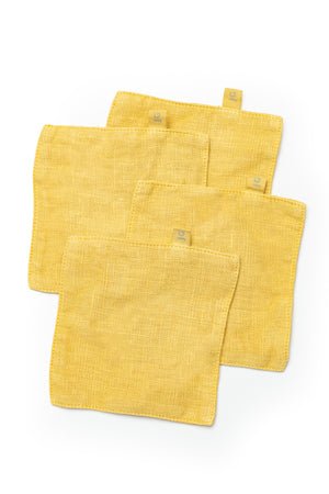 four Jenny Graham Home LINEN COASTERS (SET OF 4) on a white background.