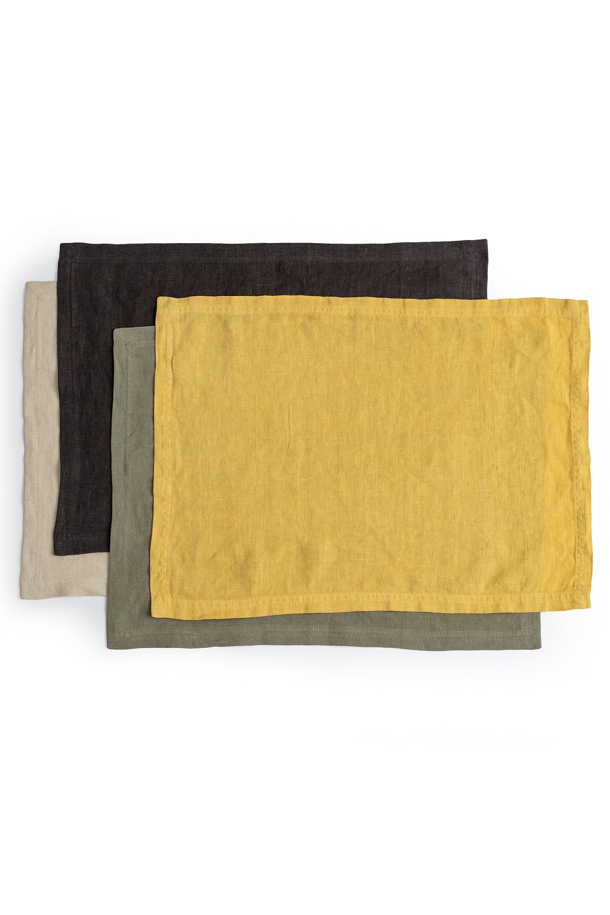 Three Jenny Graham Home linen placemats accessorize the table on a white background.-15072810565825