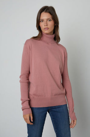 A model wearing a Velvet by Graham & Spencer RENNY turtleneck sweater for fall.