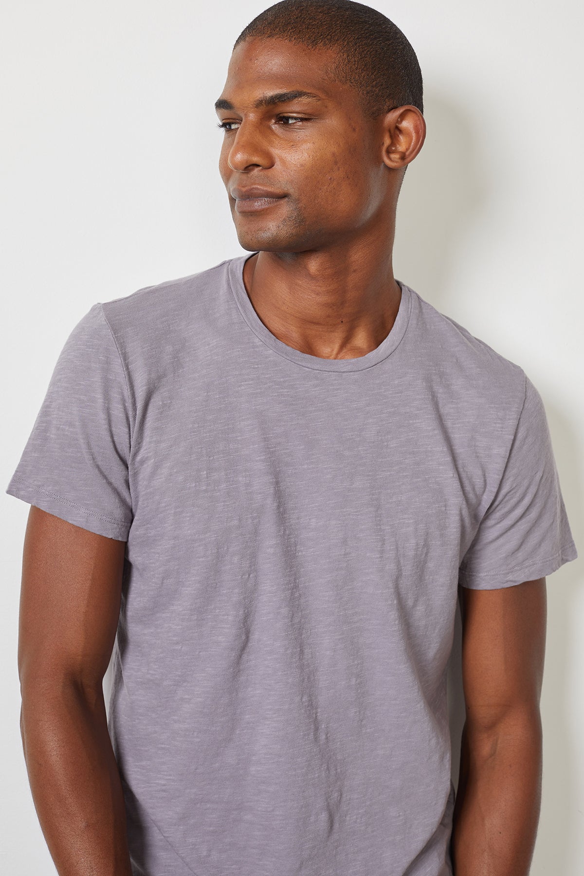 A man wearing a Velvet by Graham & Spencer DION CREW NECK TEE with a heathered texture.