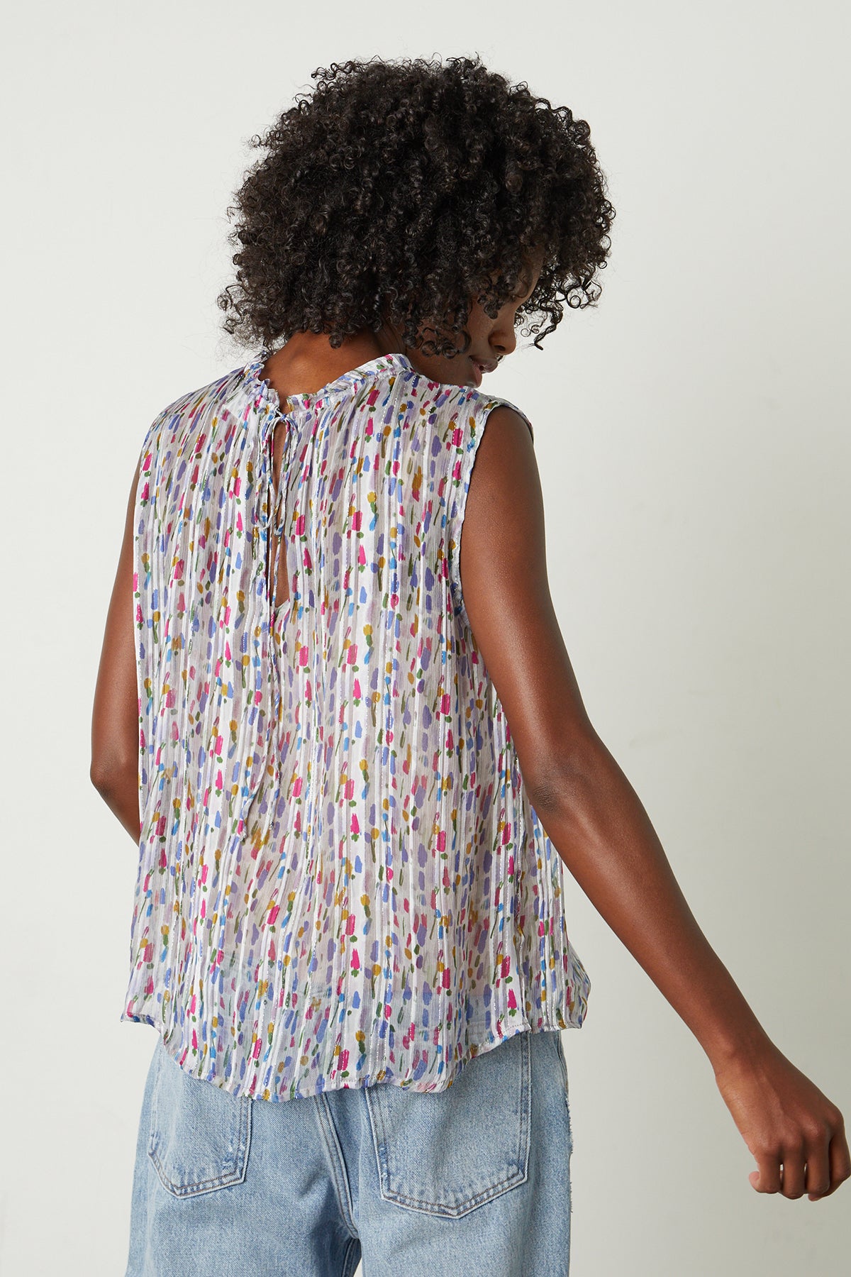The back view of a woman wearing a Velvet by Graham & Spencer NADINE PRINTED LUREX STRIPE TANK TOP.