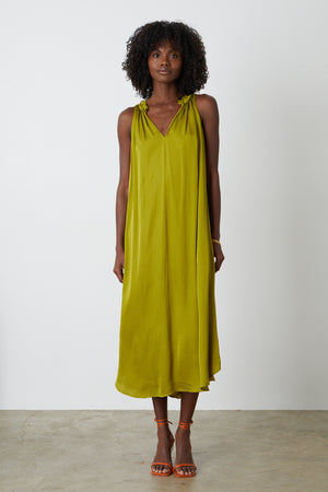 Tala dress in meadow green full length front with orange sandals