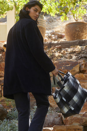 Christine Faux Sherpa Coat in black back view with black denim and Frayed Flannel Weekend Bag in plaid