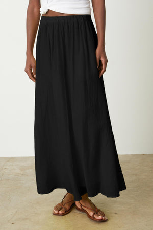 A woman wearing a Velvet by Graham & Spencer MARIELA MAXI SKIRT.