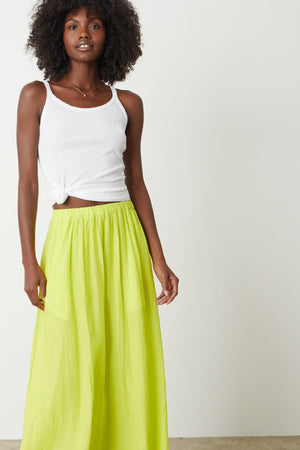 The model is wearing a MARIELA MAXI SKIRT by Velvet by Graham & Spencer.