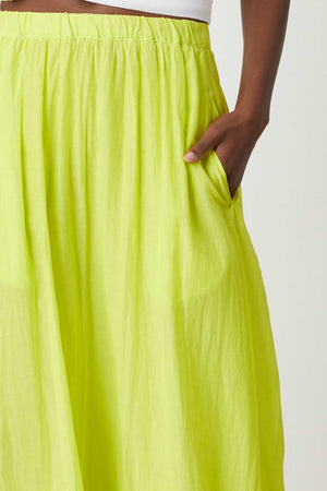 A woman wearing a Velvet by Graham & Spencer MARIELA MAXI SKIRT pocket detail