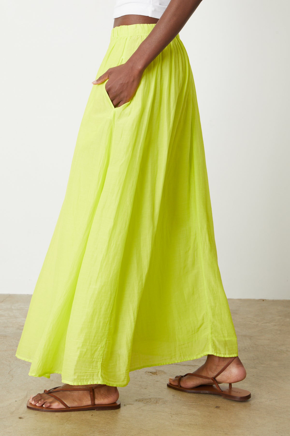 a woman wearing a Velvet by Graham & Spencer Mariela Maxi Skirt and white sandals.-26262258057409
