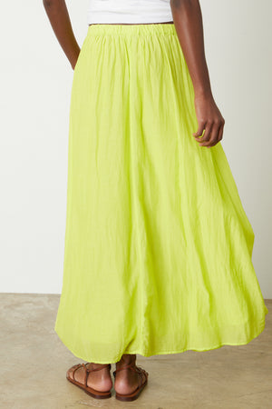 The back view of a woman wearing a Velvet by Graham & Spencer MARIELA MAXI SKIRT.