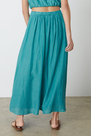 The back view of a woman wearing the Velvet by Graham & Spencer MARIELA MAXI SKIRT.
