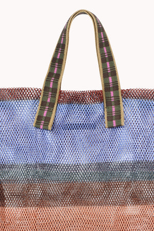 Close-up of the SMALL STRIPED MESH TOTE BY EPICE, featuring bold blue, brown, and orange bands with striped handles—Epice’s tote blends striking colors and natural fibers in a compact, stylish design.