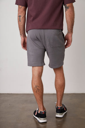 The casual man appears in the back view, dressed in Velvet by Graham & Spencer's JAXSON DRAWSTRING SHORT.