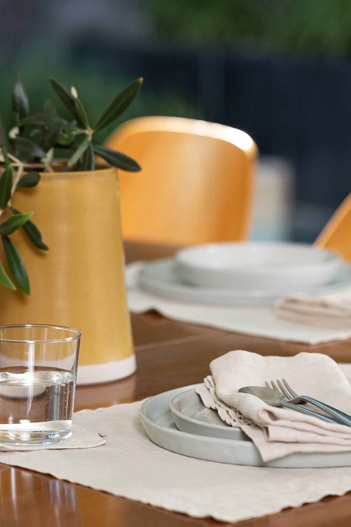 a set of 4 LINEN COASTERS by Jenny Graham Home on a wooden table.-15229477880001
