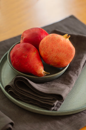 A Jenny Graham Home linen napkin on a table, an everyday kitchen essential with a luxe finish.