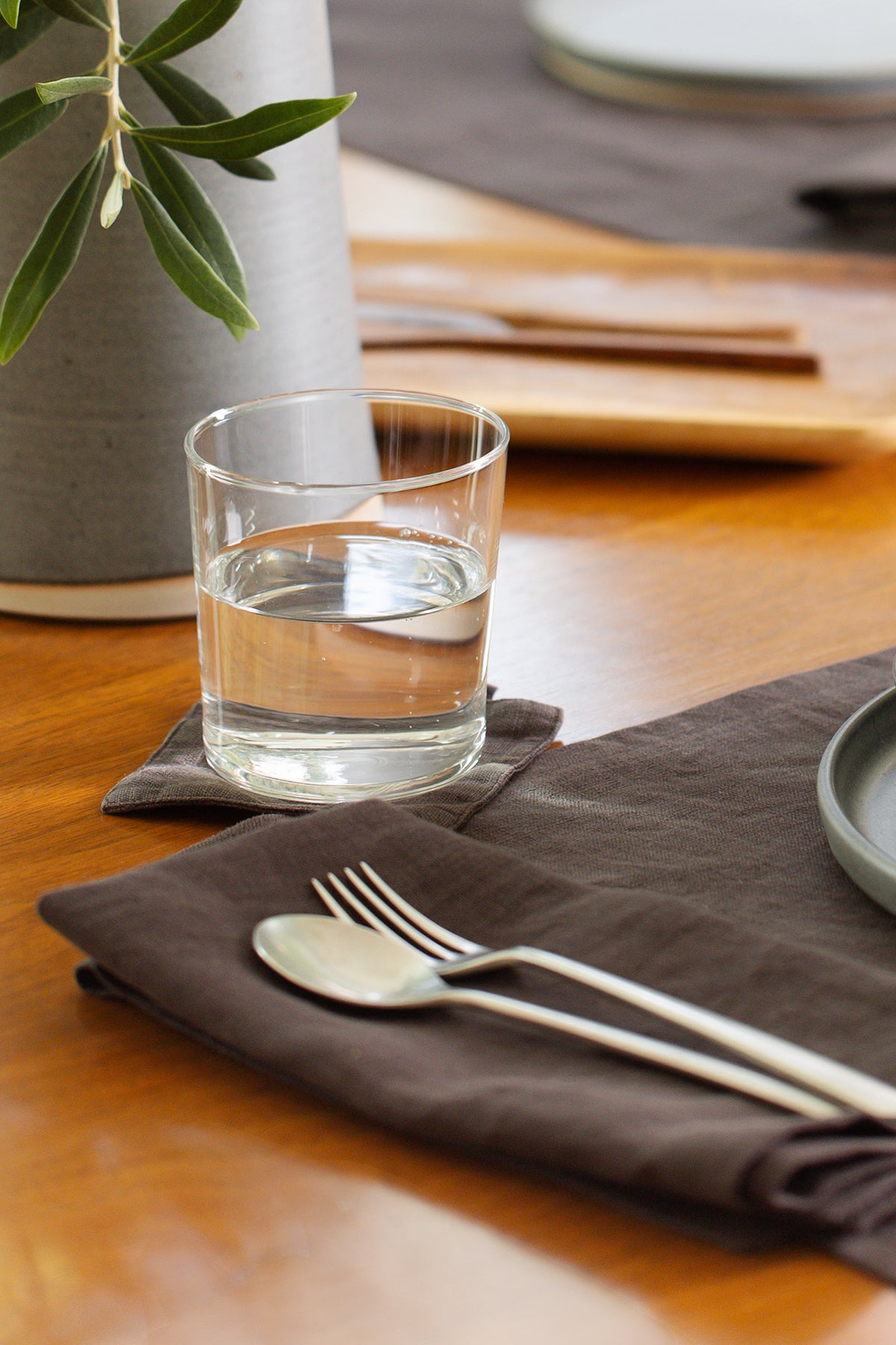 a set of Jenny Graham Home linen coasters (set of 4) on a table.-15229306896577
