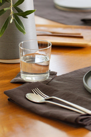 a set of Jenny Graham Home linen coasters (set of 4) on a table.