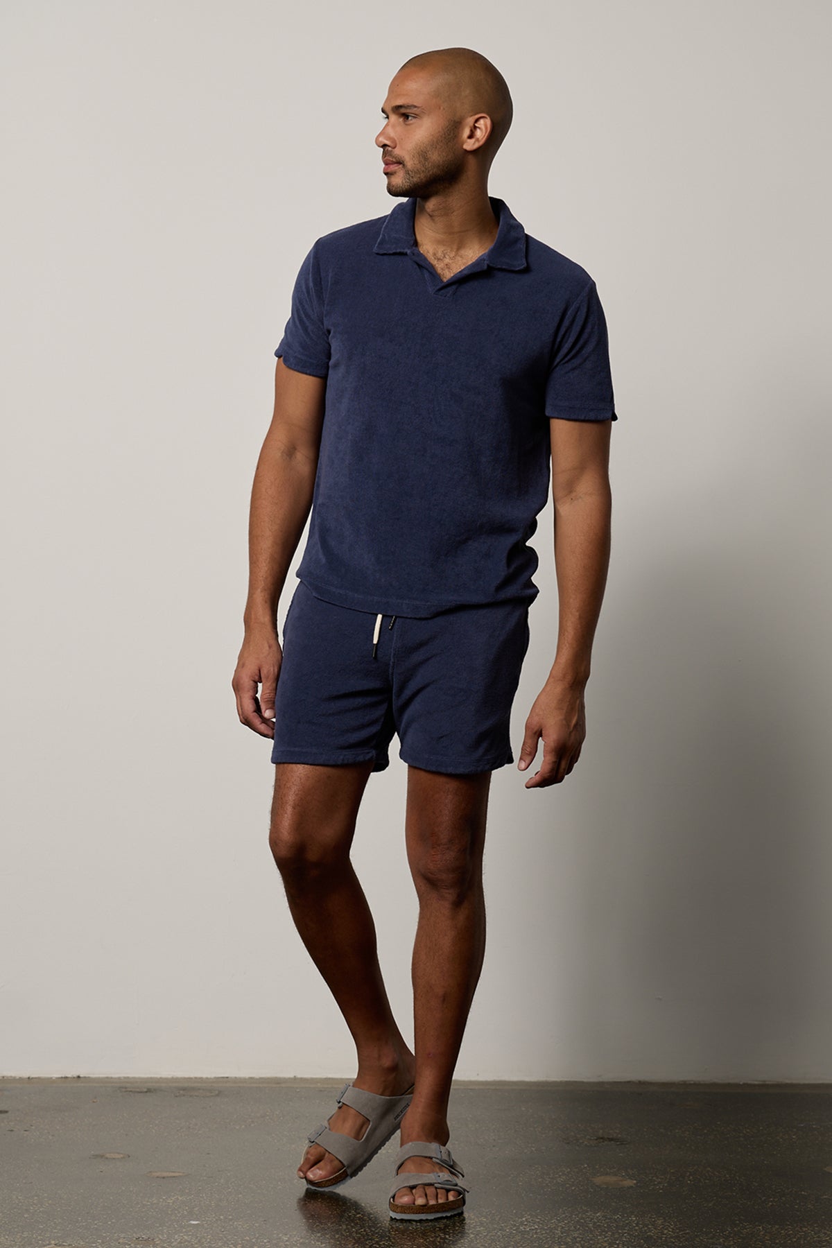 A man wearing a Velvet by Graham & Spencer OZZIE TERRY SHORT in navy.