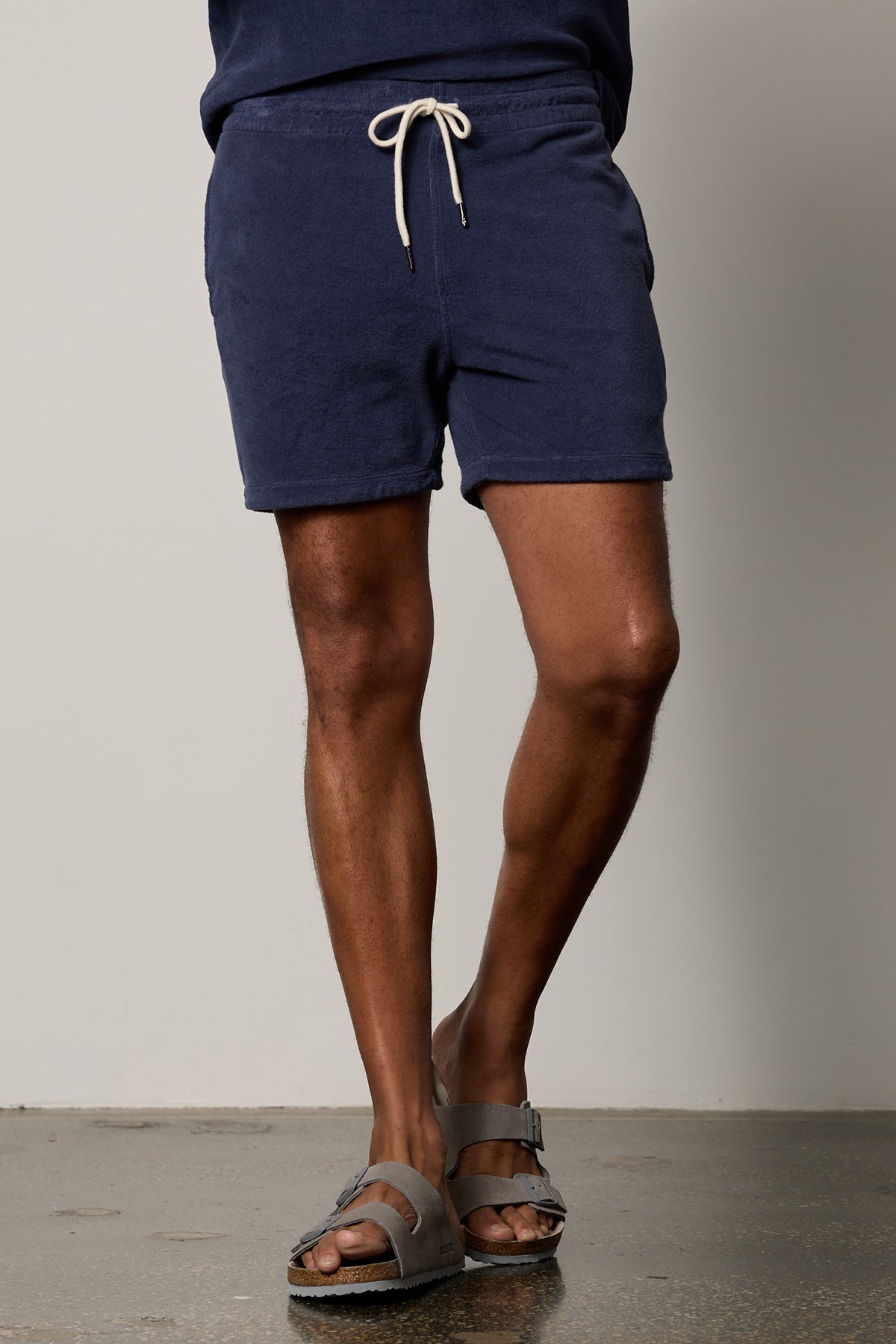 A man wearing a pair of Velvet by Graham & Spencer OZZIE TERRY SHORT and sandals.-26266333151425