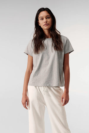 a woman wearing a Velvet by Jenny Graham Topanga Tee and white pants.