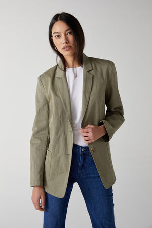 The model is wearing an ECHO BLAZER by Velvet by Jenny Graham and jeans.