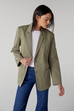 The model is wearing a Velvet by Jenny Graham ECHO BLAZER and jeans.