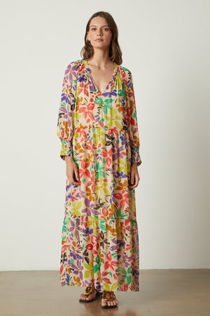 A woman wearing a SERENA PRINTED MAXI DRESS by Velvet by Graham & Spencer.