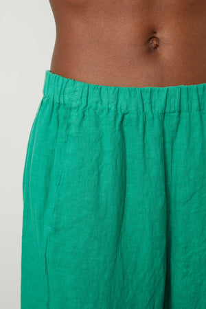 Waist detail of Lola linen pant in apple.