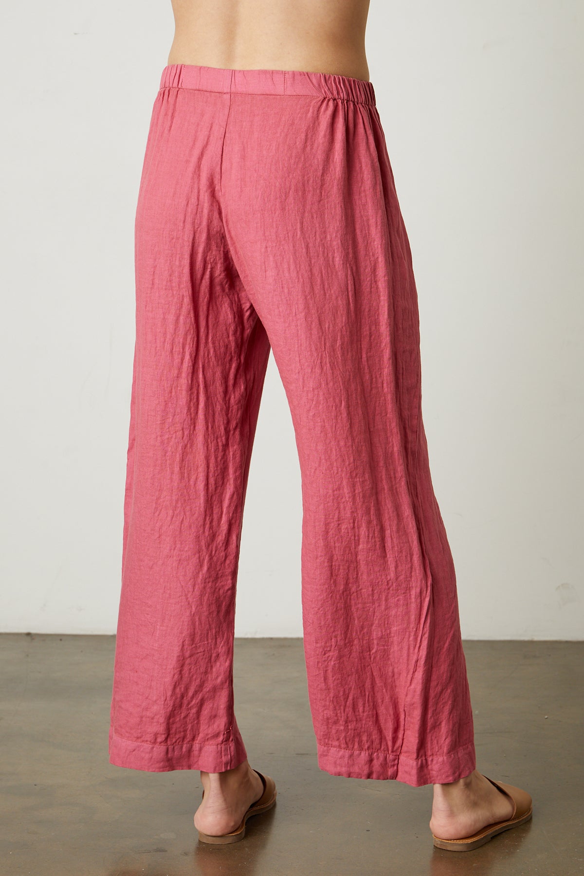 The lightweight woven Velvet by Graham & Spencer LOLA LINEN PANT back view of a woman wearing pink pull-on trousers.-25329014046913