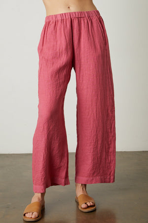A woman wearing Velvet by Graham & Spencer's LOLA LINEN PANT and lightweight linen woven sandals.