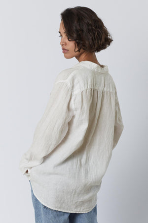 The back view of a woman wearing a Velvet by Jenny Graham Mulholland shirt.