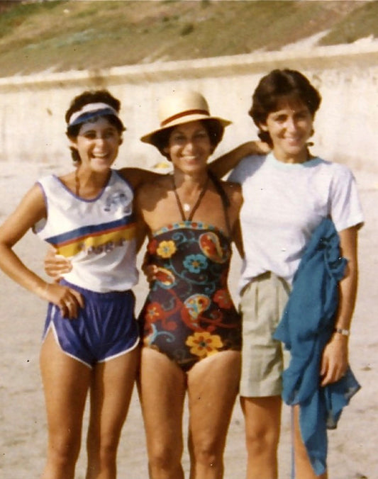 Three people pose together outdoors in vintage summer clothing