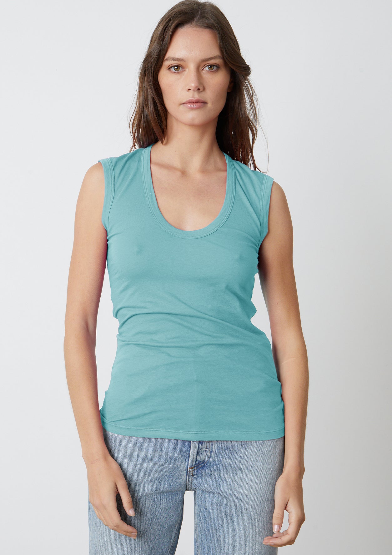 A woman wearing a Velvet by Graham & Spencer ESTINA GAUZY WHISPER FITTED TANK TOP.