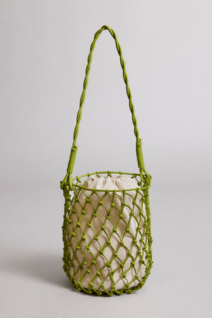 A lime green Velvet by Graham & Spencer mesh-designed tote bag with a braided strap and a light beige drawstring pouch inside, set against a neutral background.