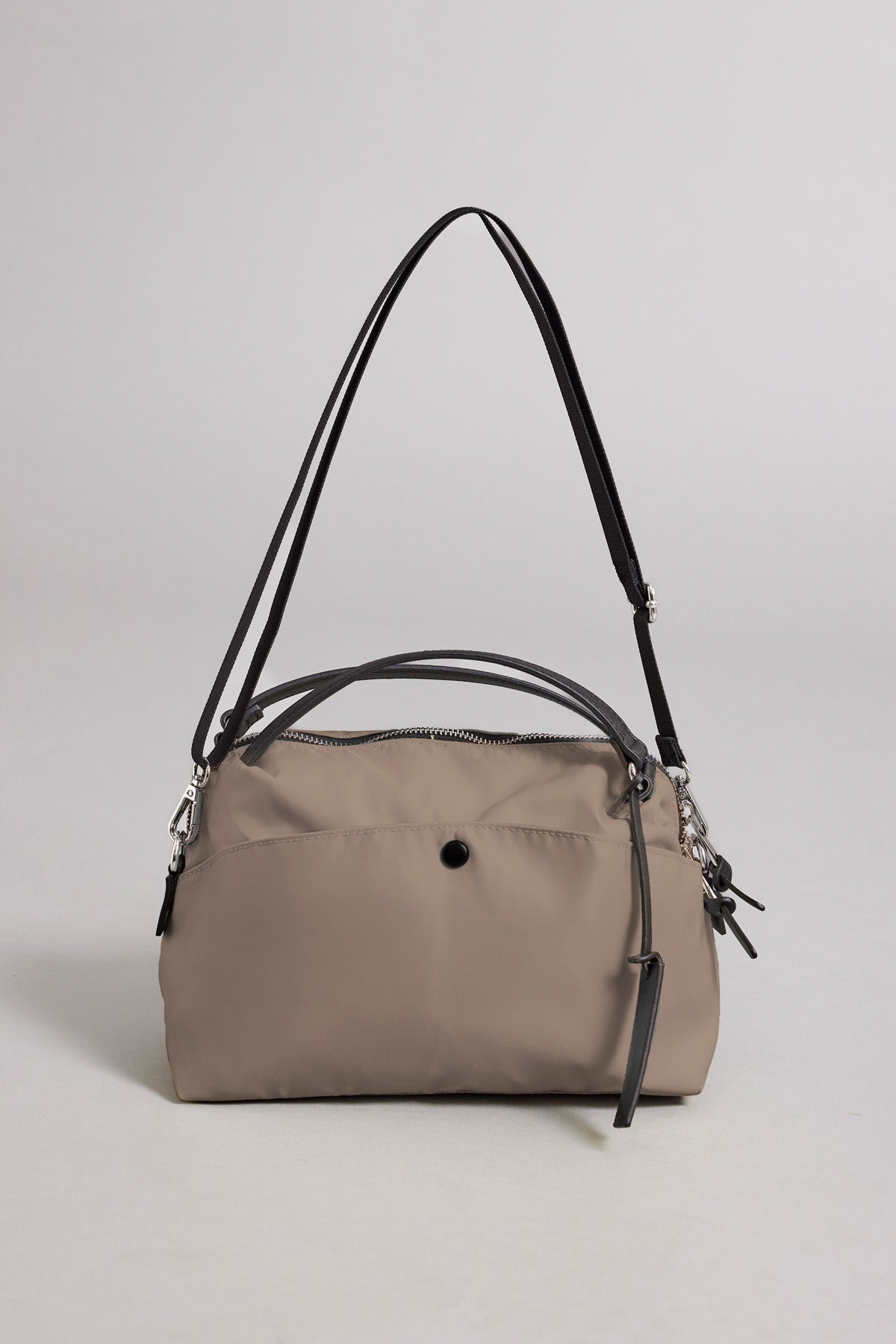 Introducing the NYLON CROSSBODY BAG by Velvet by Graham & Spencer—a taupe everyday bag crafted from durable nylon, featuring black leather handles, silver hardware, and a secure zip closure. Shown against a plain light background.-41819569488065