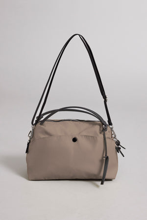 Introducing the NYLON CROSSBODY BAG by Velvet by Graham & Spencer—a taupe everyday bag crafted from durable nylon, featuring black leather handles, silver hardware, and a secure zip closure. Shown against a plain light background.