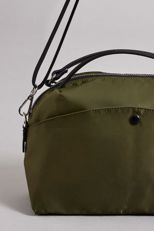 A NYLON CROSSBODY BAG by Velvet by Graham & Spencer with a black handle and shoulder strap, featuring a secure zipper closure on the top and an external buttoned pocket, crafted from durable nylon.