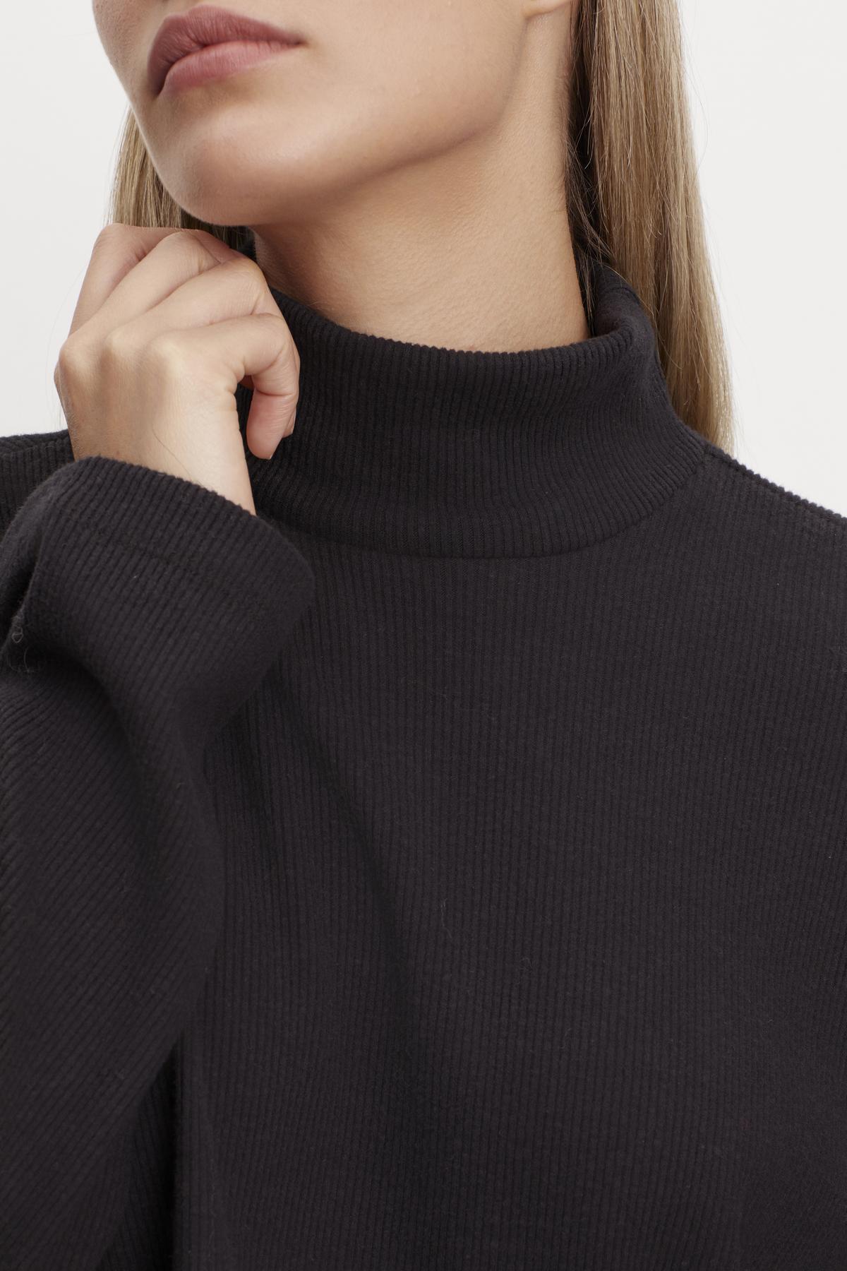   A woman in a Velvet by Graham & Spencer ALEC BRUSHED RIB MOCK NECK TOP. 