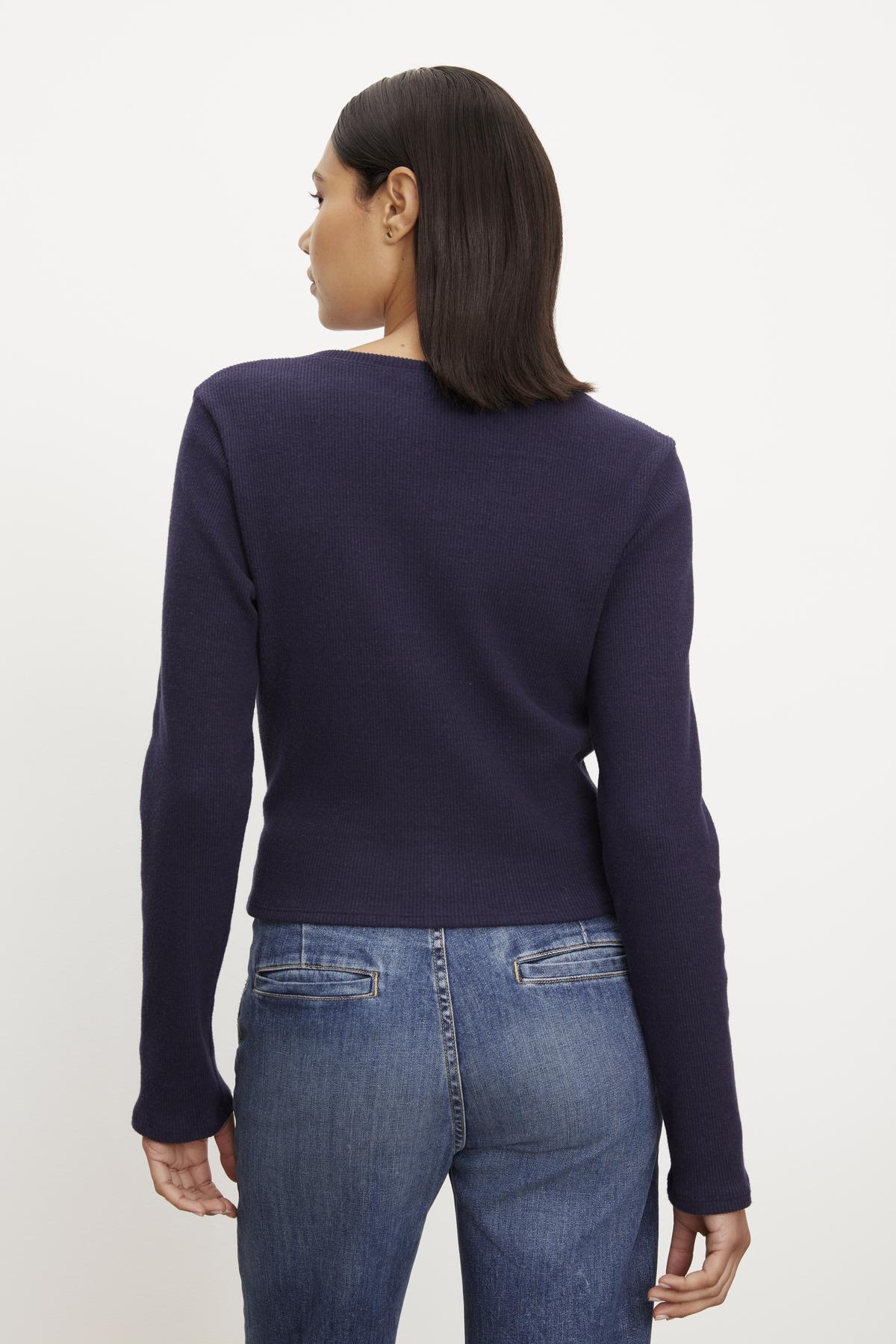 The back view of a woman wearing GEONNA BRUSHED RIB TOP by Velvet by Graham & Spencer.-36095790088385