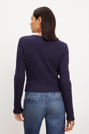 The back view of a woman wearing GEONNA BRUSHED RIB TOP by Velvet by Graham & Spencer.