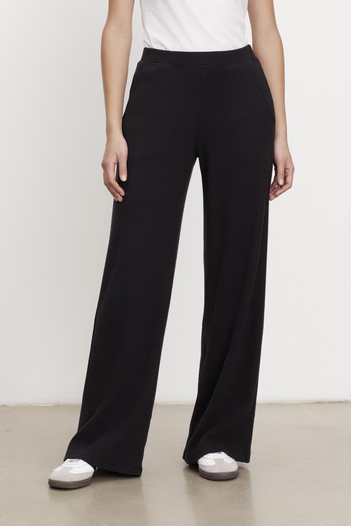 A woman wearing Velvet by Graham & Spencer KACIE BRUSHED RIB PANT and a white t-shirt.-35701975285953