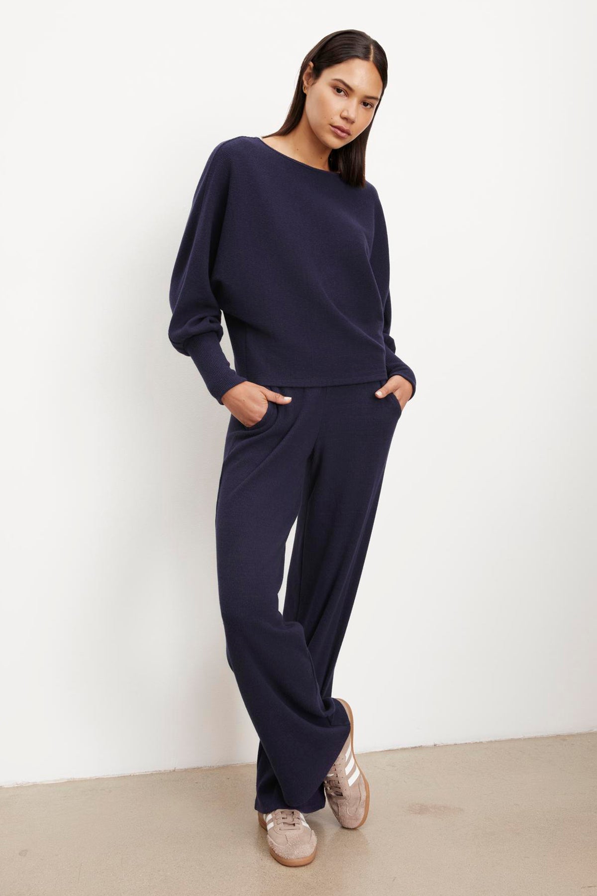 The model is wearing a Velvet by Graham & Spencer KACIE BRUSHED RIB PANT jumpsuit.-35701975417025