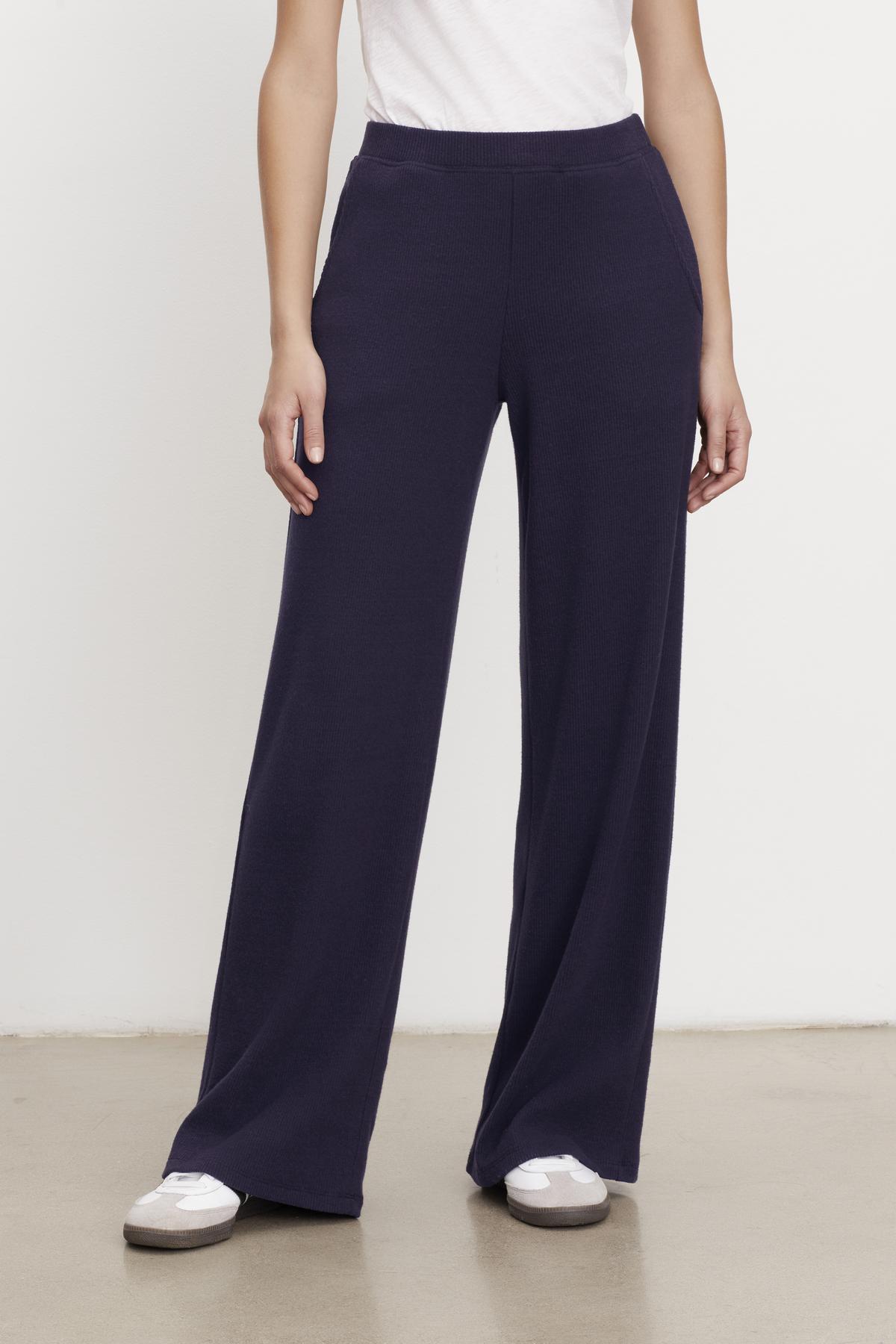   A woman wearing Velvet by Graham & Spencer's KACIE BRUSHED RIB PANT and white t-shirt. 